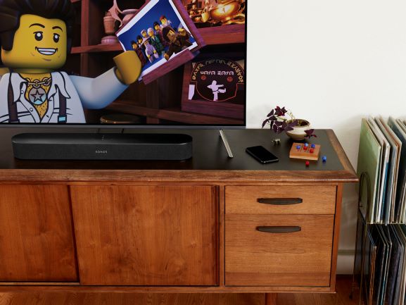 Sonos Beam on Home Entertainment Centre, with Lego Movie playing on TV