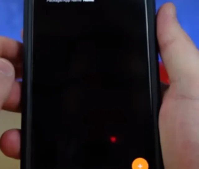Picture of someone holding android phone with Tasker task on display