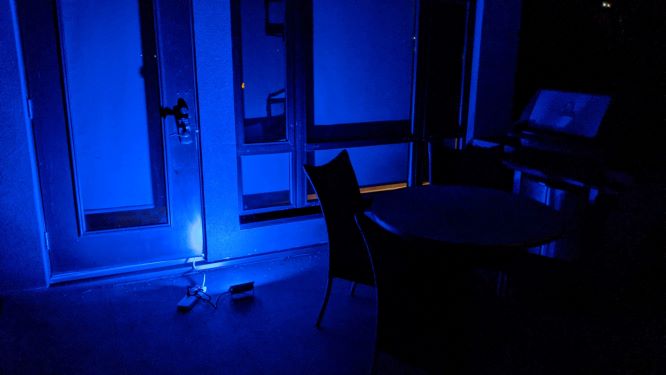 Novostella Smart LED Floodlights shining blue light against the house