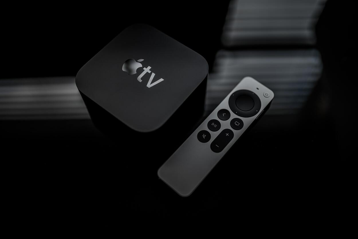 An aesthetic shot of the all powerful Apple TV and its compatible remote.