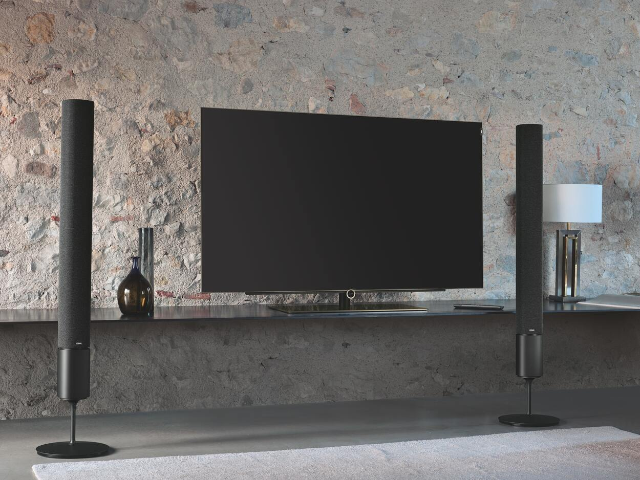 Flat screen smart television with tower speakers.