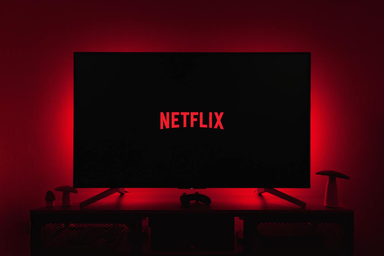 TV with Netflix with red backlighting in a dark room