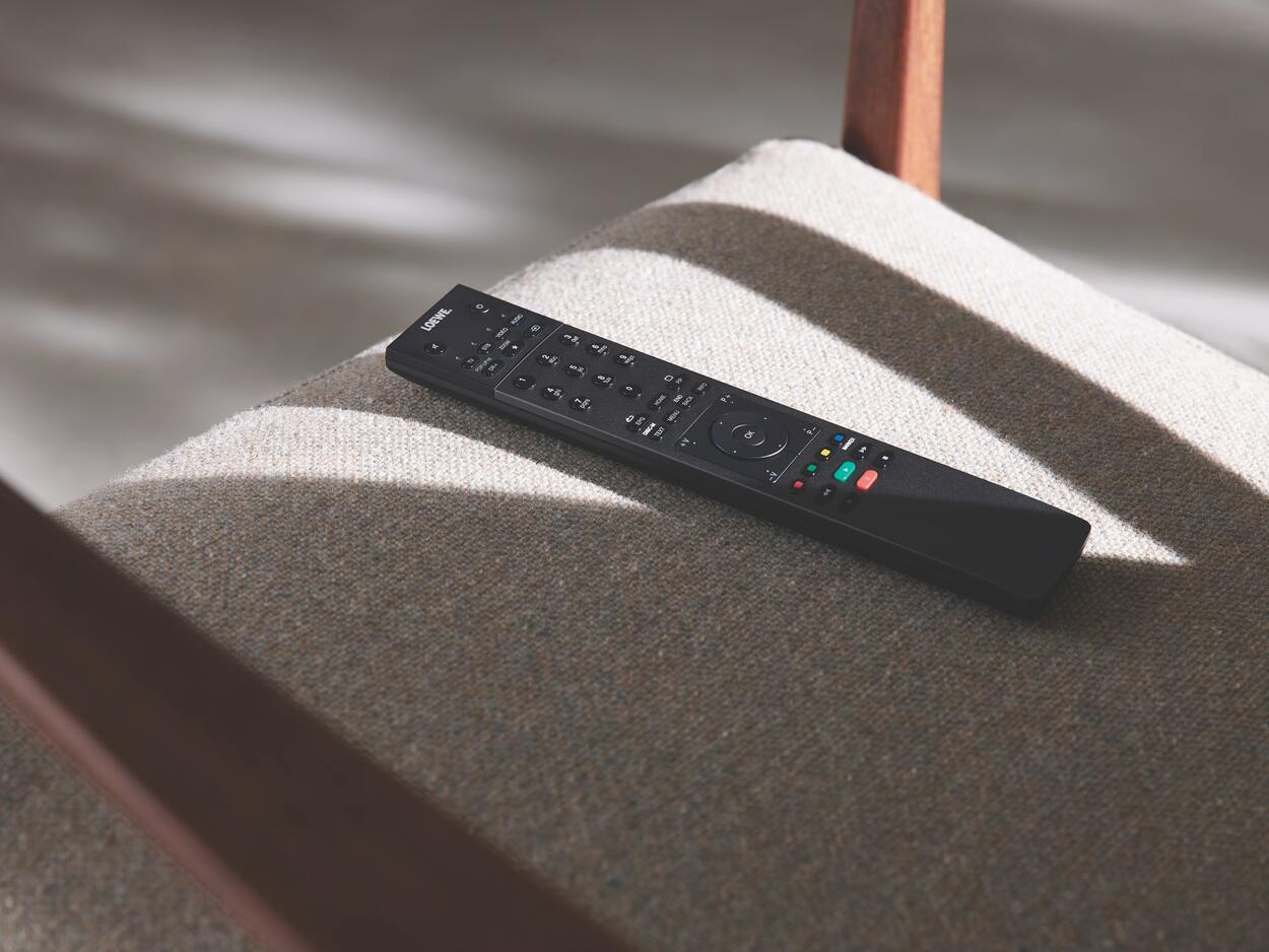 Smart TV remote [;aced on a piece of furniture