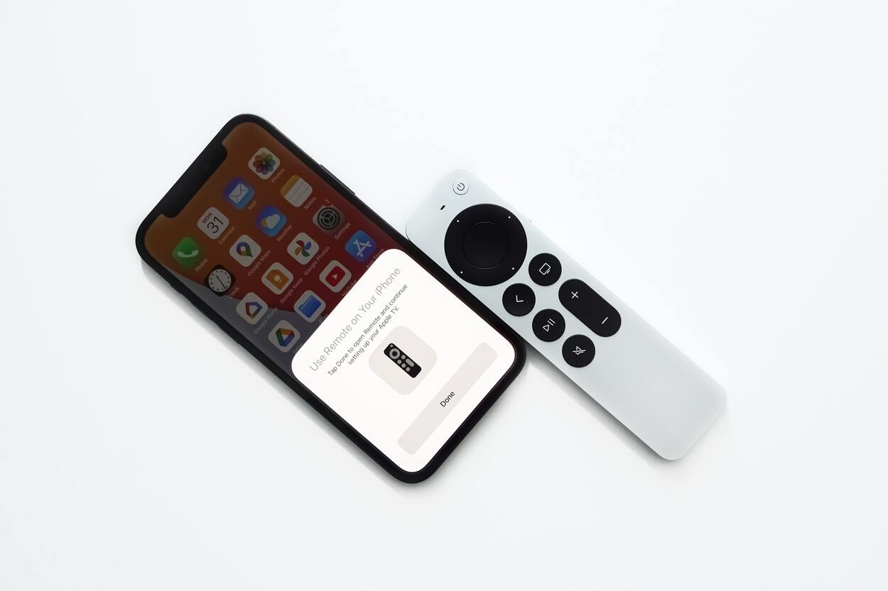 Apple TV remote placed beside an iphone