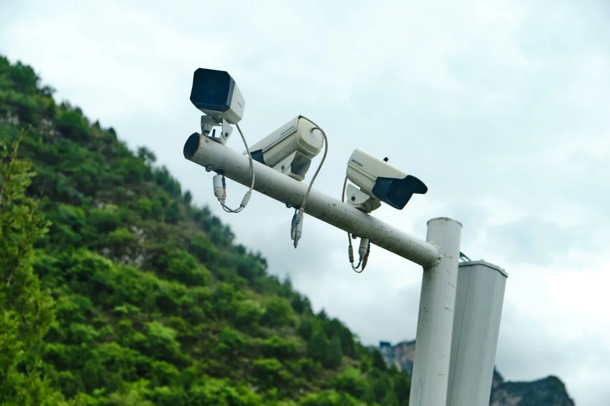 Multiple security cameras mounted on a pole.