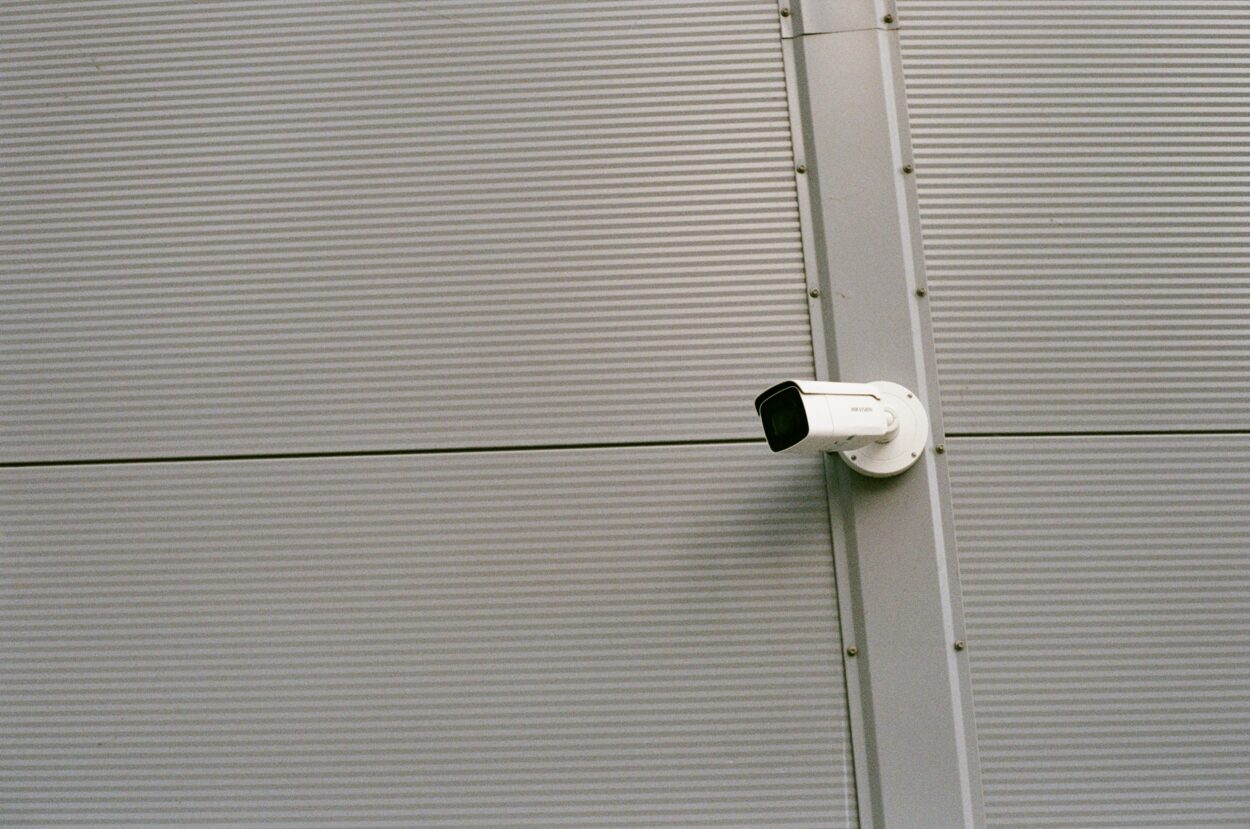White and Black Surveillance camera mounted.