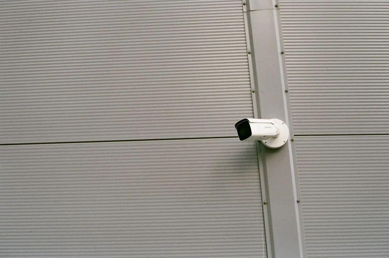 White and Black Surveillance camera mounted.