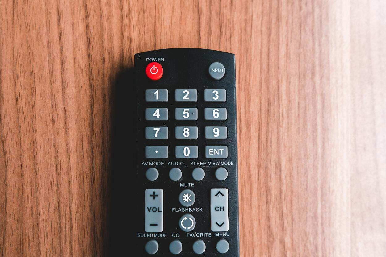 TV remote on wooden background