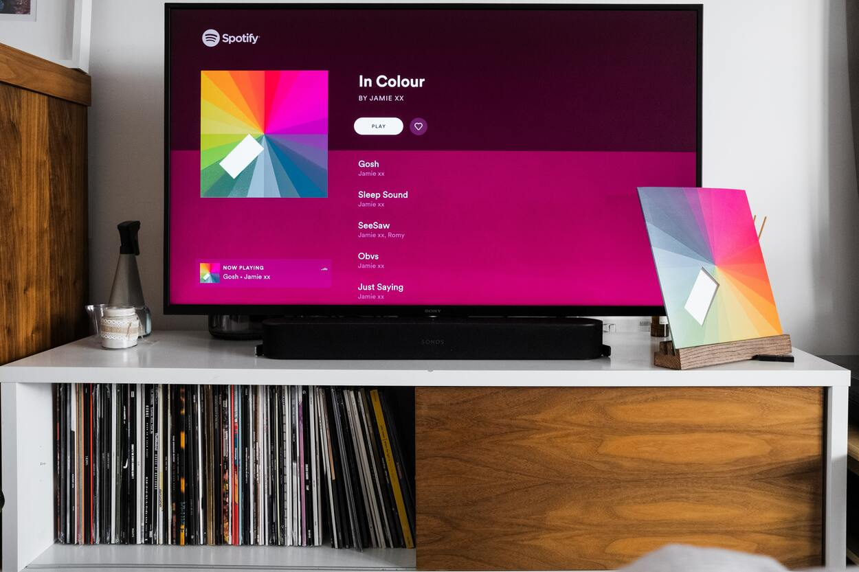 A flat-screen TV playing music on Spotify