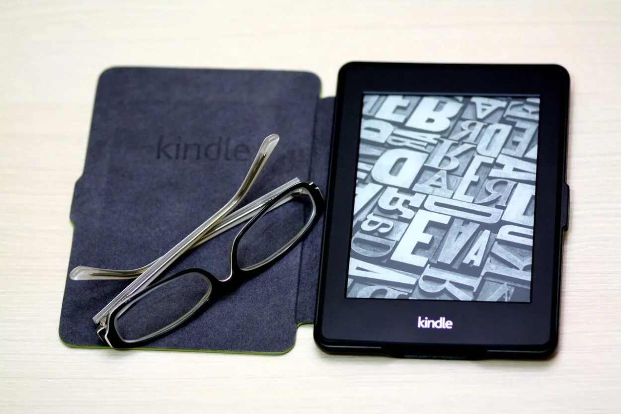 Kindle with case and glasses.