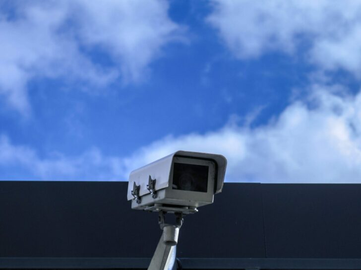 A CCTV camera and sky in the background