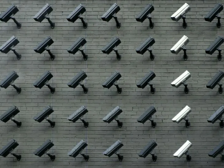 A bunch of cameras installed on a wall facing in the same direction