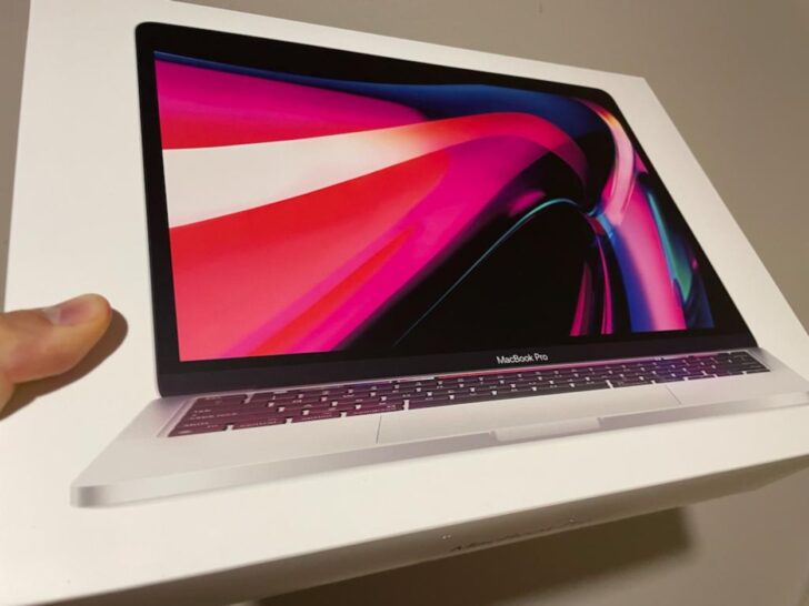 A person holding a macbook pro