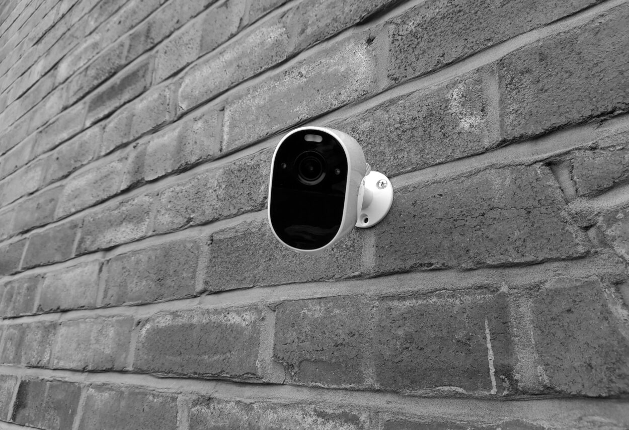 A security camera installed on a brick wall