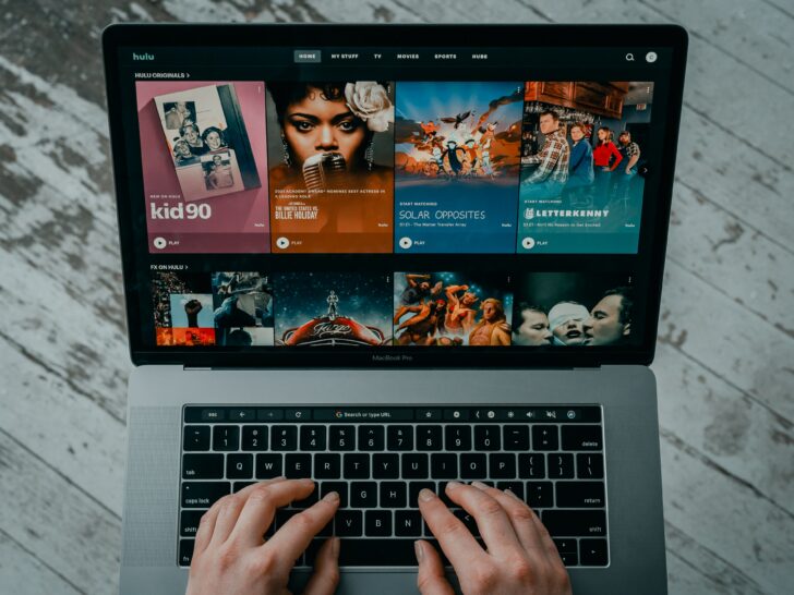 Aperson using laptop displaying Hulu home page