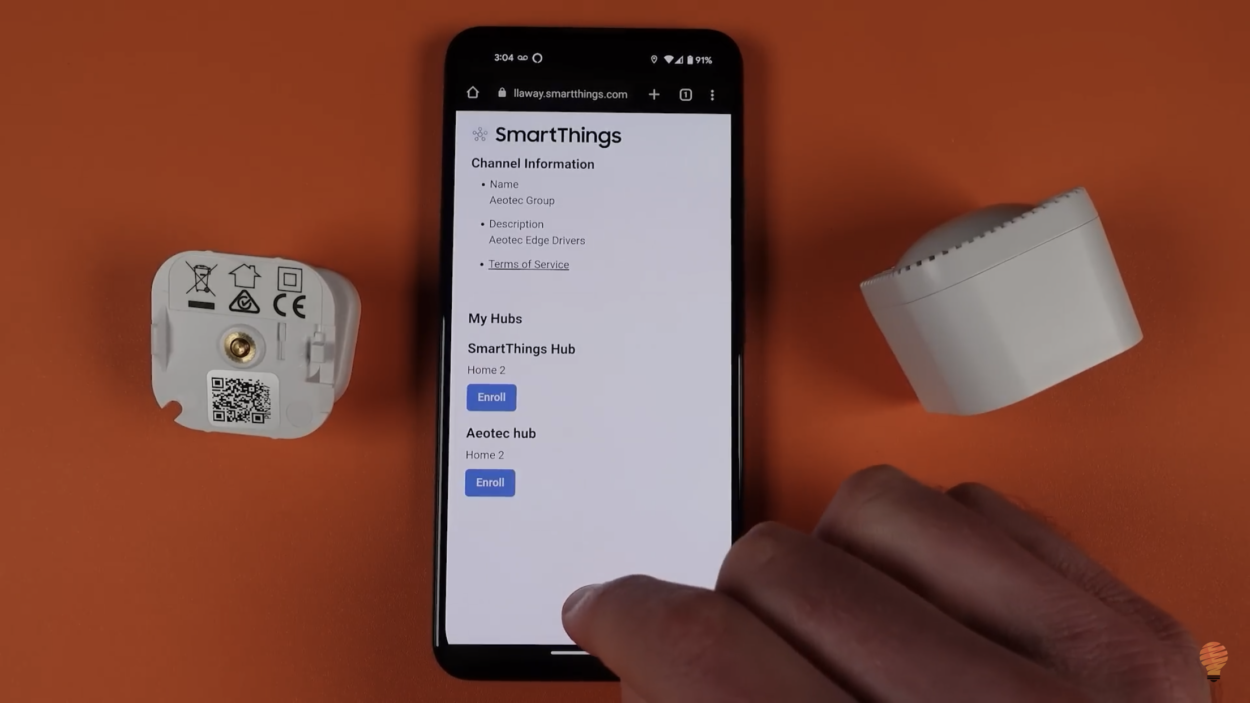 A phone displaying SmartThings app with the Aeotec MultiSensor 7 placed beside it