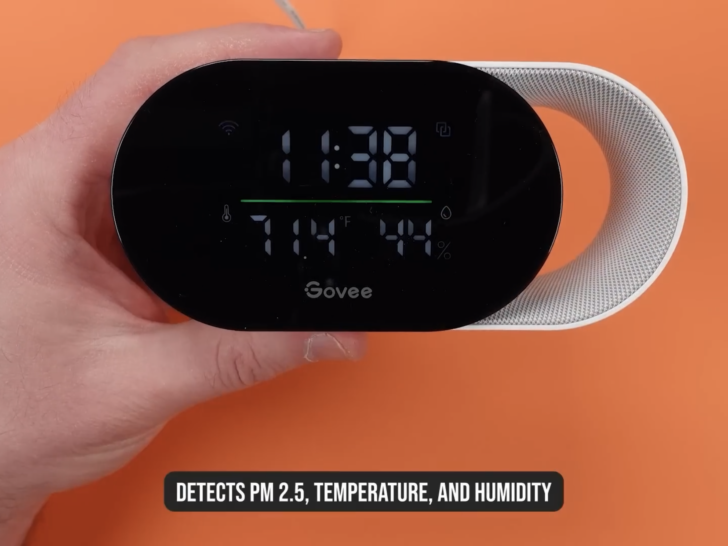 A person reviewing the Govee Air Quality sensor holding the Govee device
