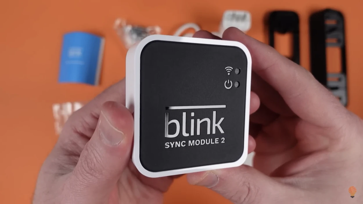 A person holding the Blink Sync Module 2