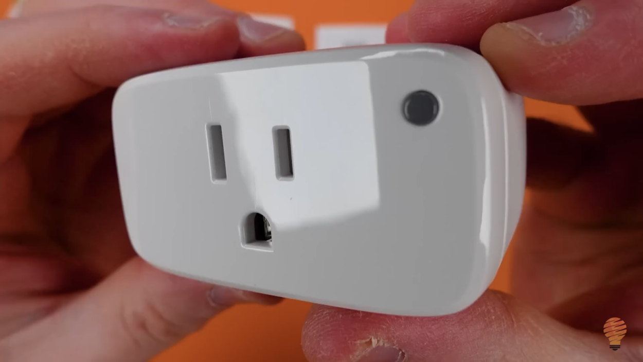 A person holding the Eve smart plug