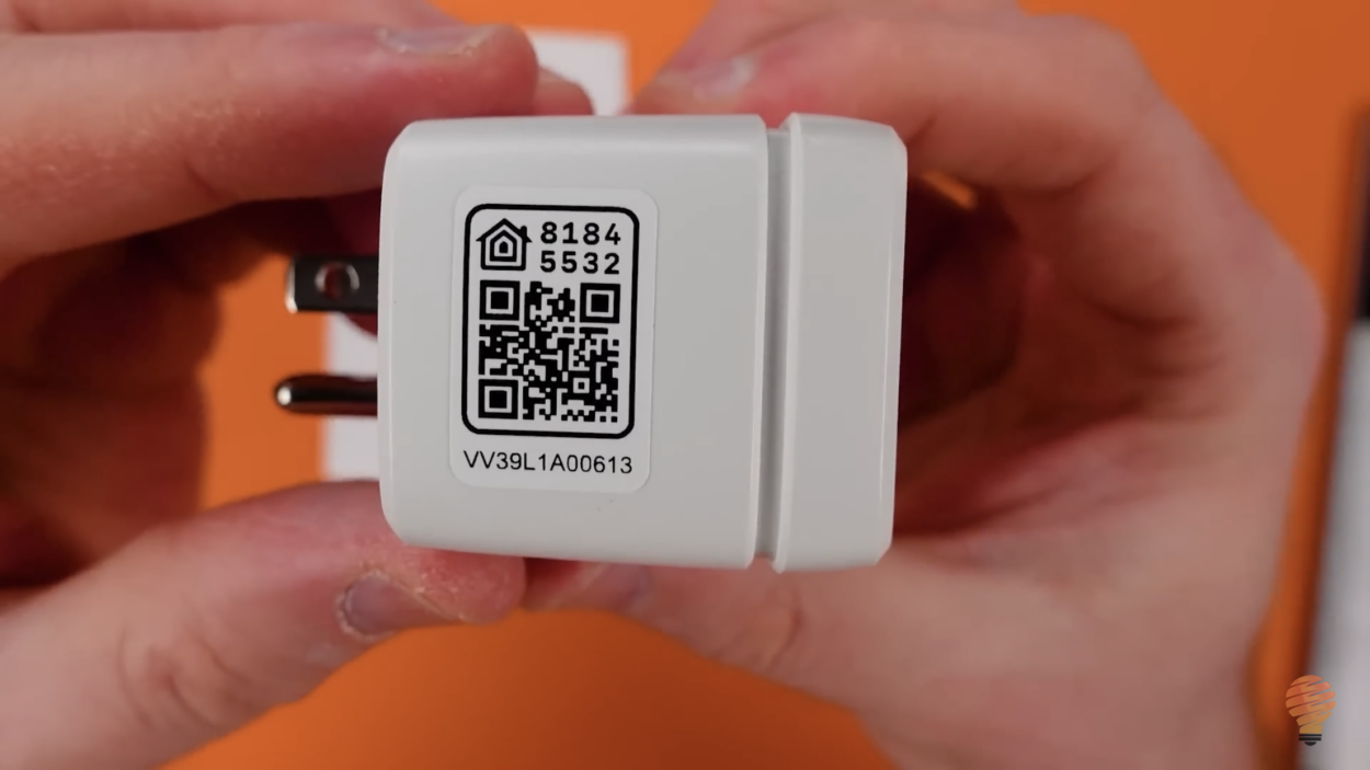 A person showing the QR code on Eve smart plug