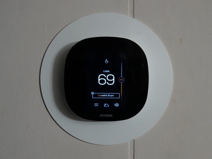A black colored Nest thermostat.