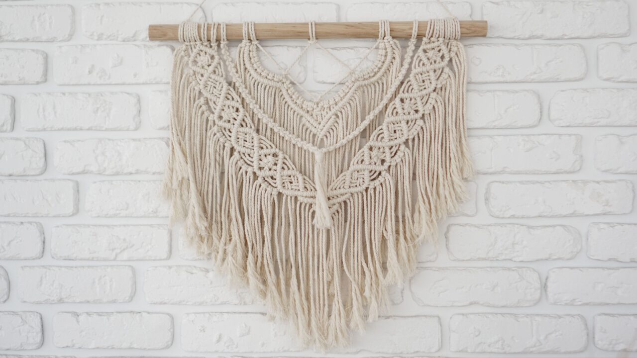 Macrame tapestry on a brick wall
