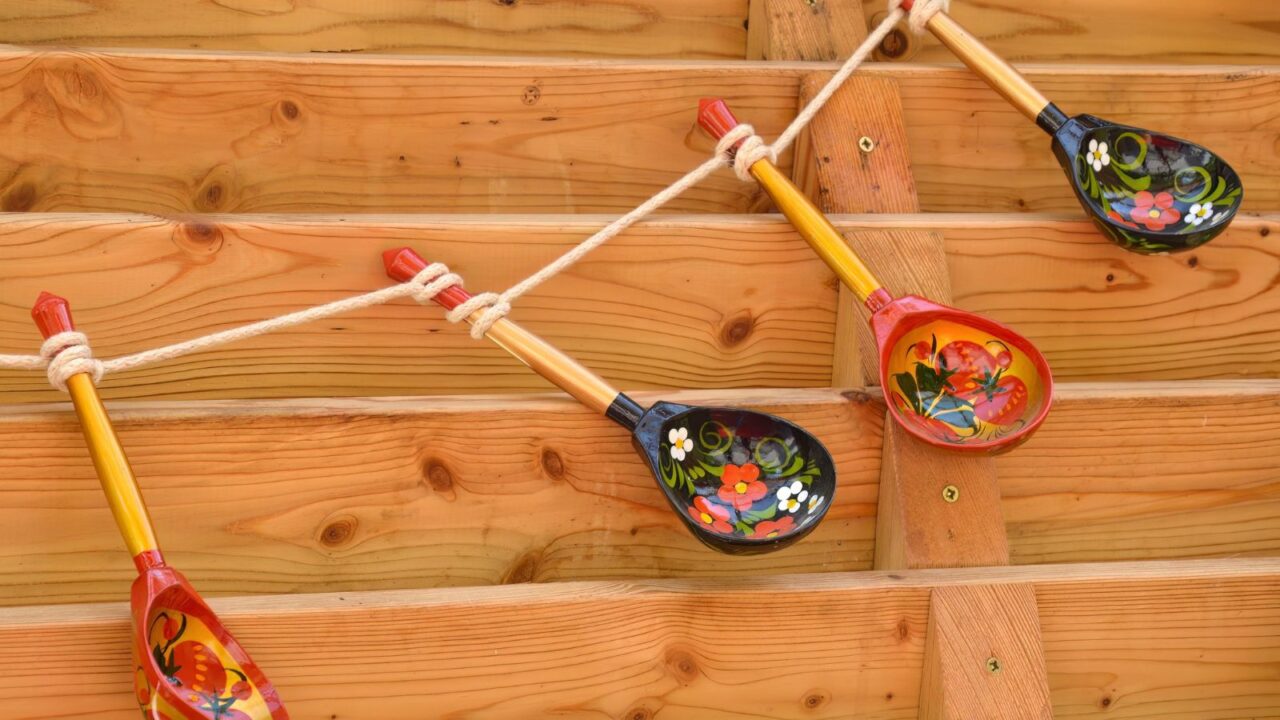 Wooden spoons hanging on rope.