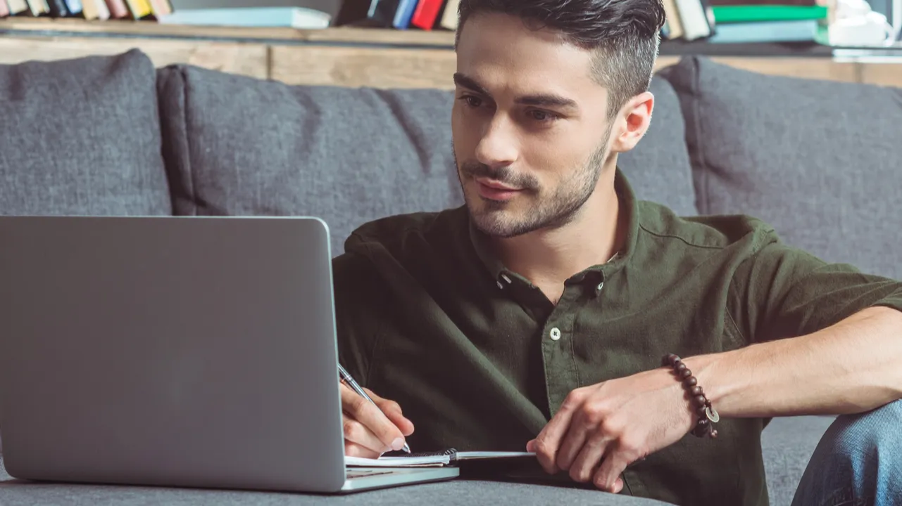 man with laptop and notebook