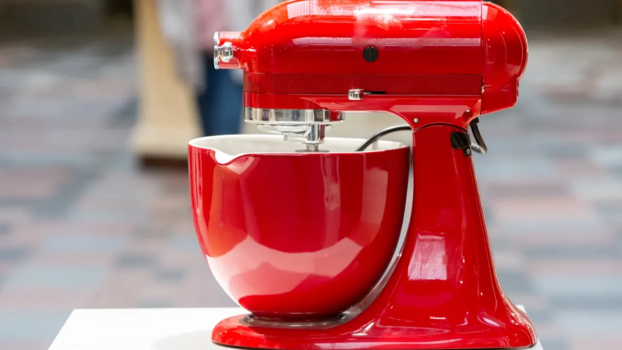 red metal food processor on a white supply