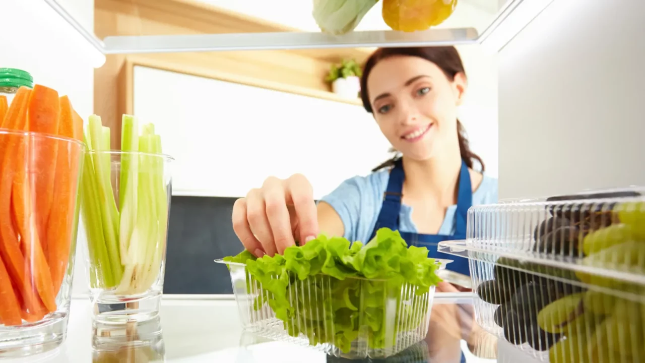 woman looking for something in the fridge at home