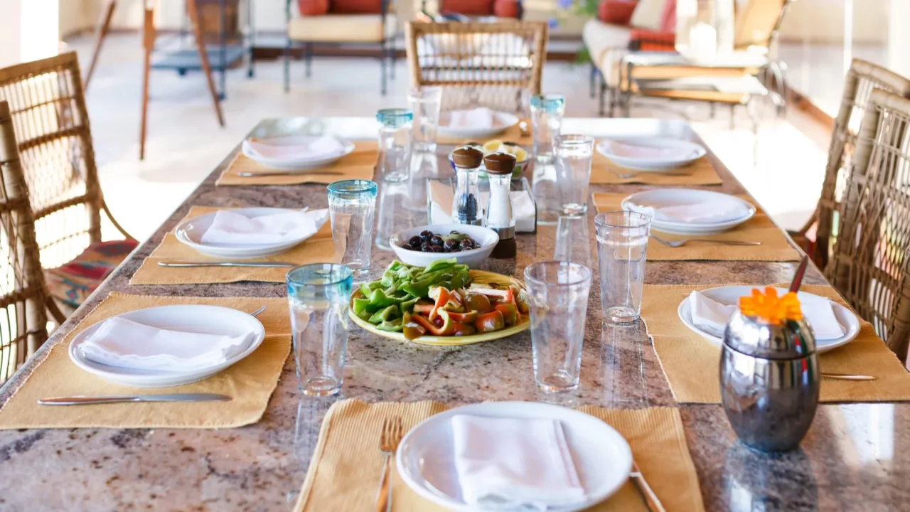 Dining table set for lunch in veranda of spanish home.