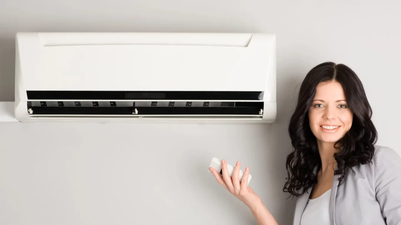 Girl Holding A Remote control Air conditioner