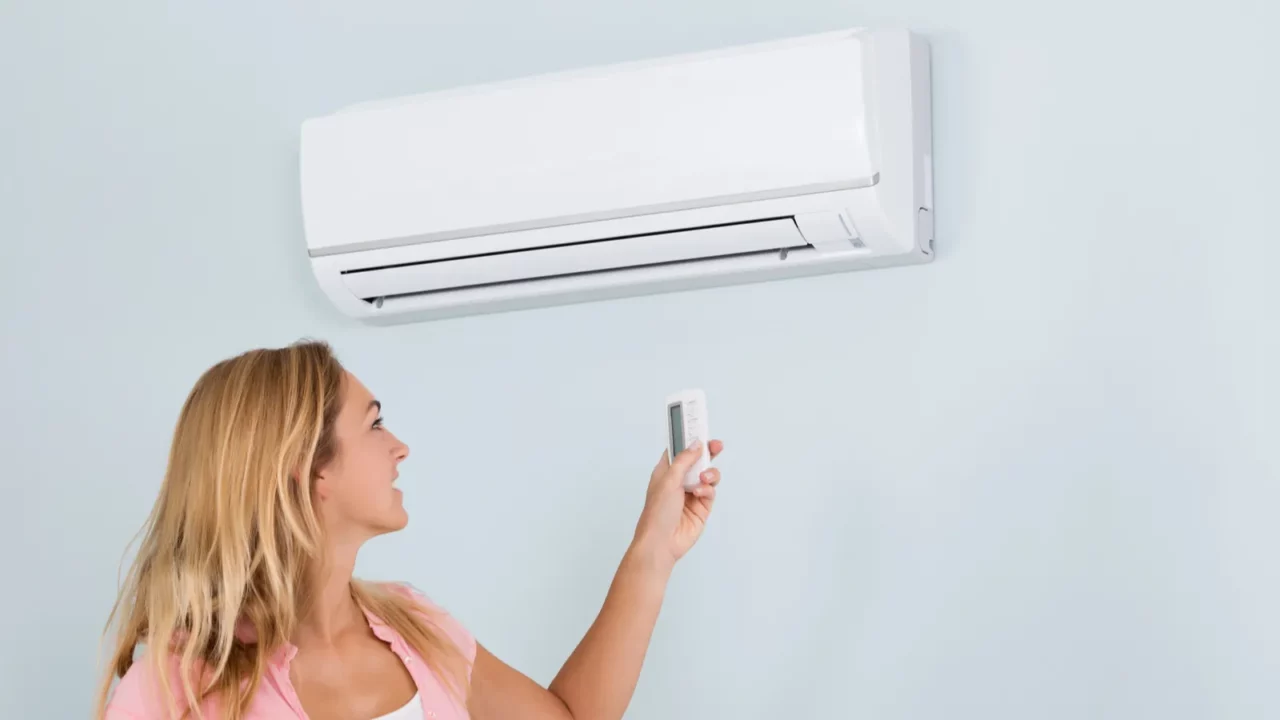 woman operating air conditioner