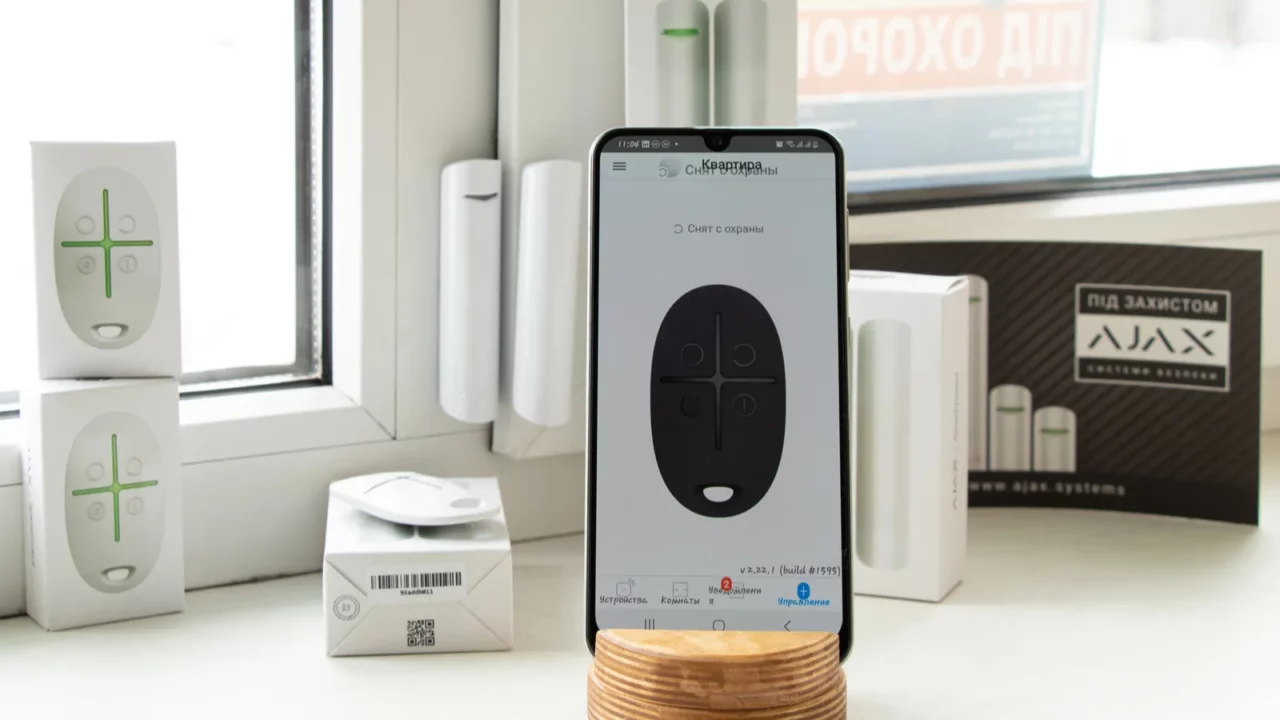 Wireless alarm lies on phone holder.