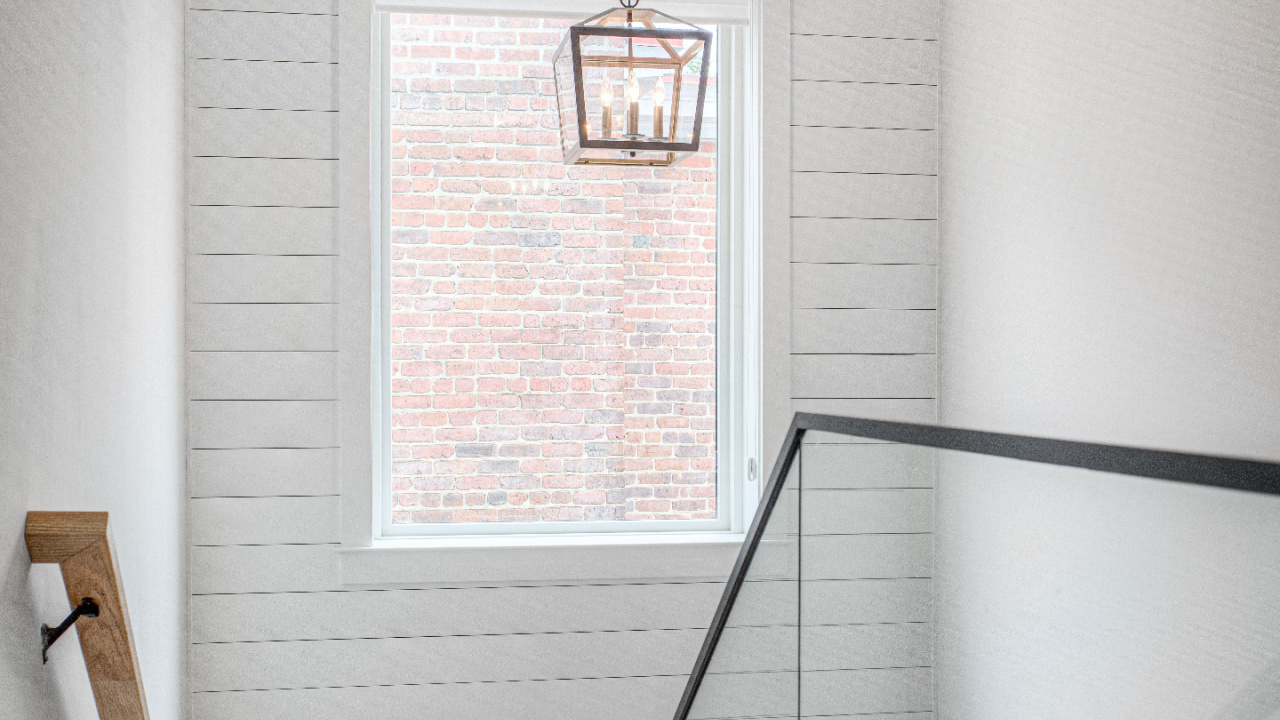 Clean modern farmhouse staircase interior with shiplap wall