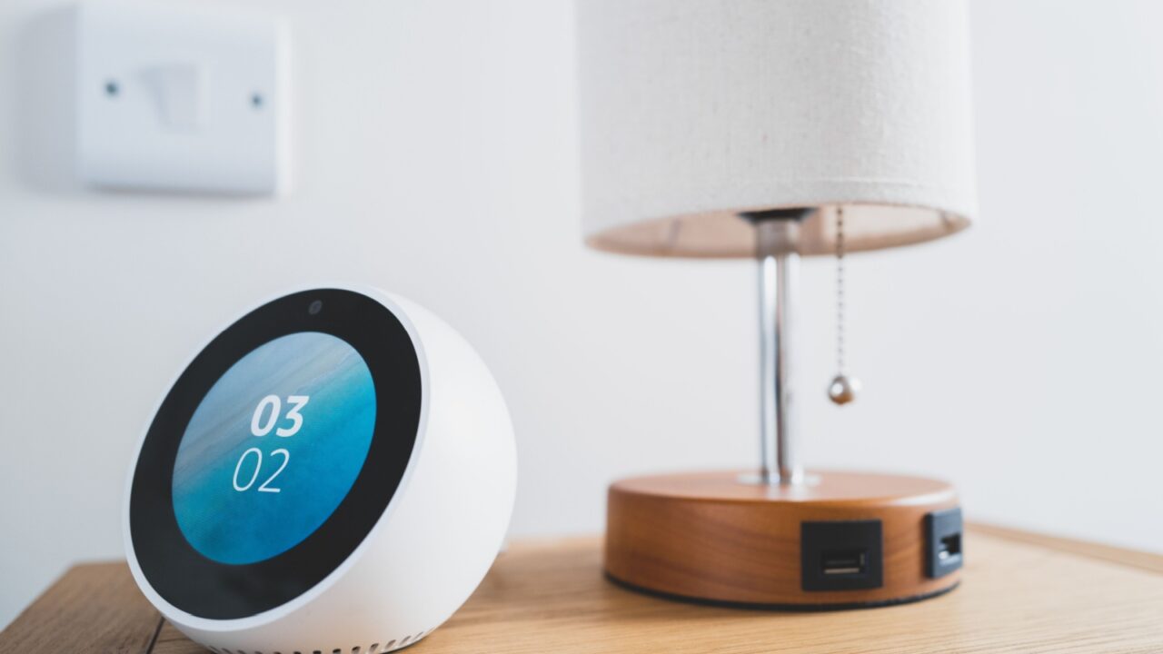 Smart alarm on a bedside table concept.