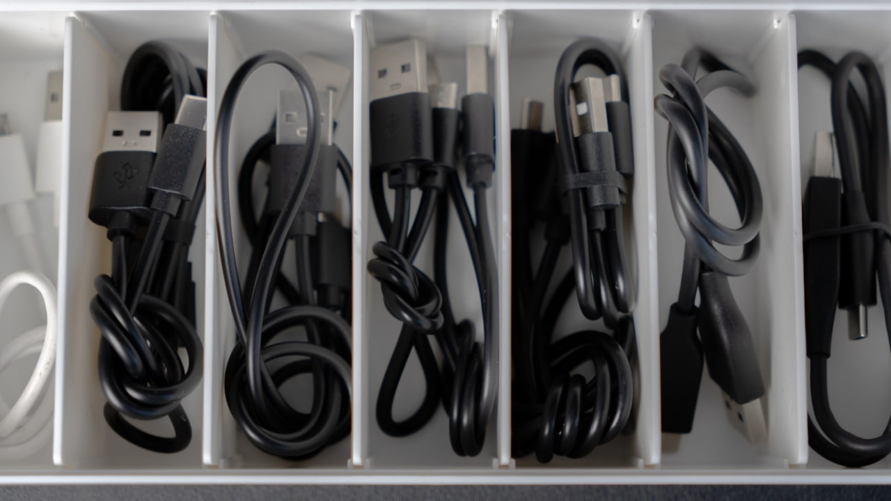 Organized box containing assorted cables and cords.