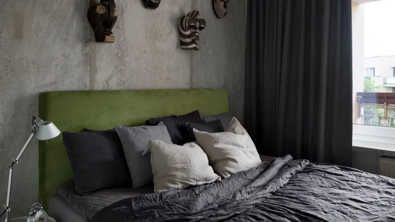bright and stylish bedroom with exposed concrete on the wall