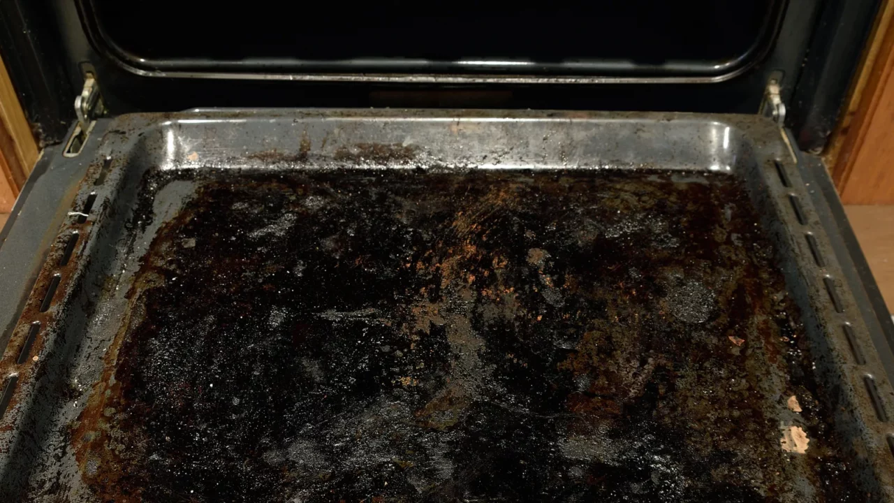 Dirty oven baking tray at kitchen