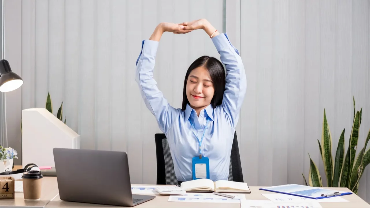 asian female accountant is tired from working in a chair