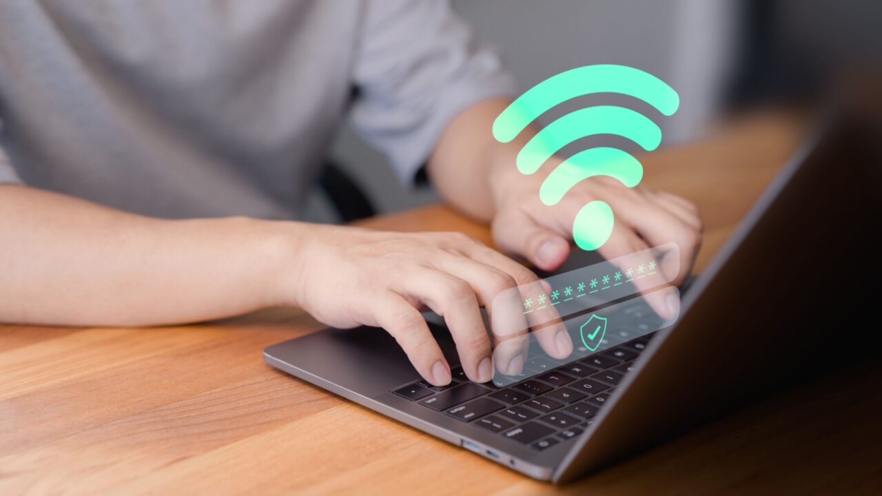 Person using a laptop with Wi-Fi.