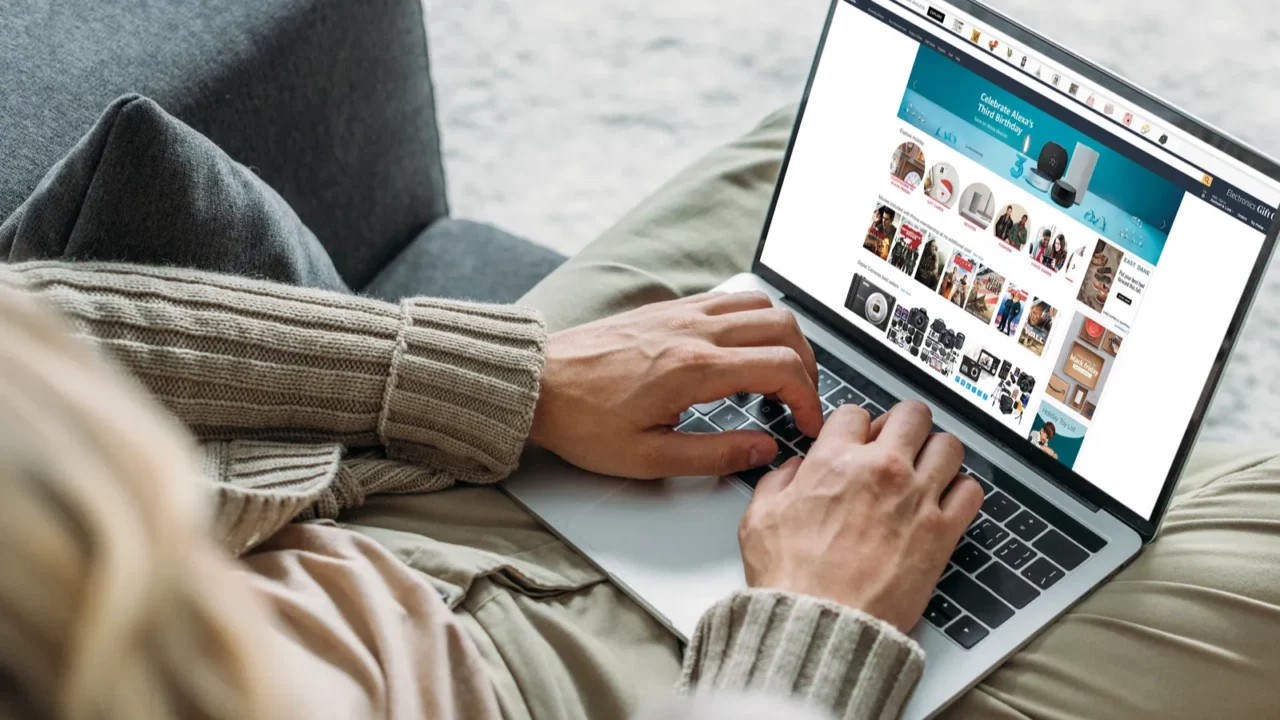 Person using laptop for online shopping.