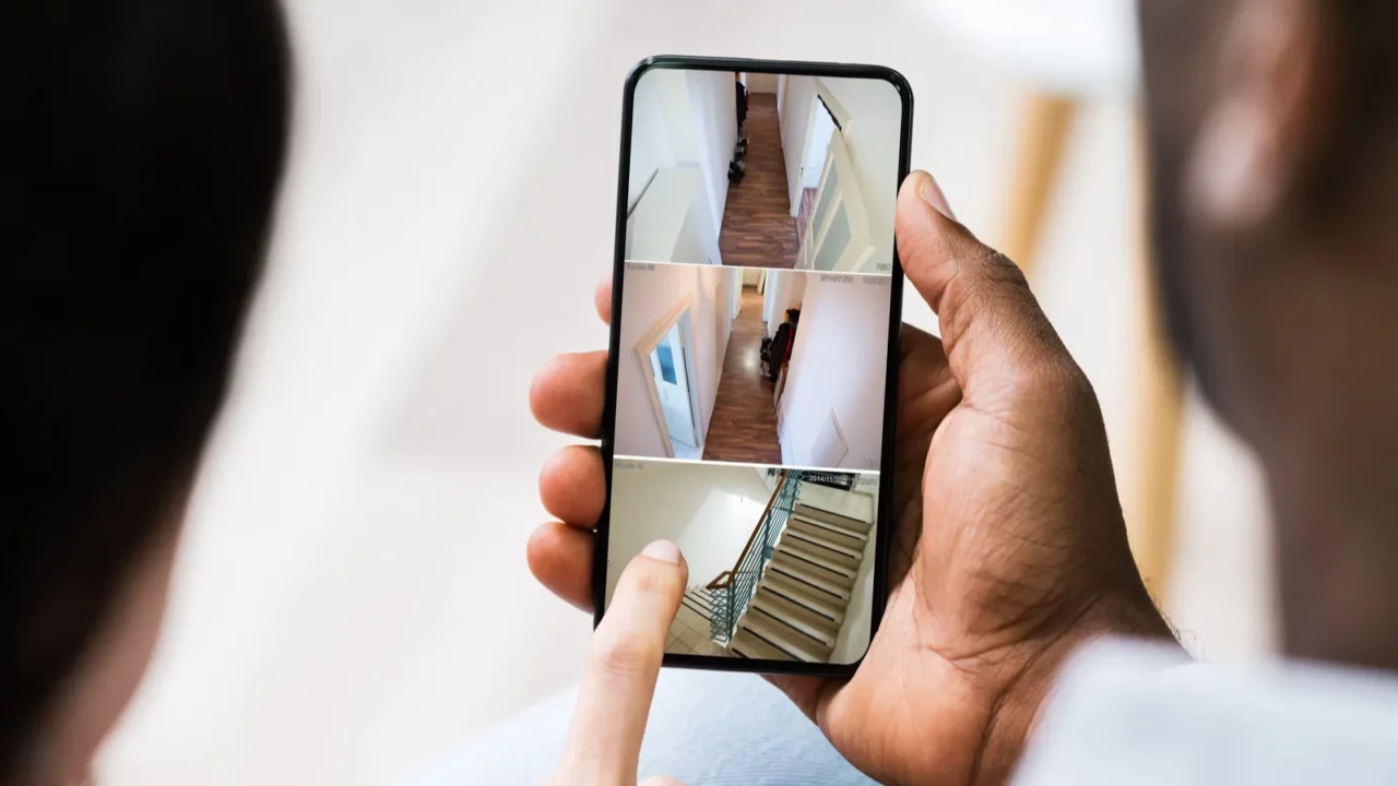 close up of a persons hand using home security system