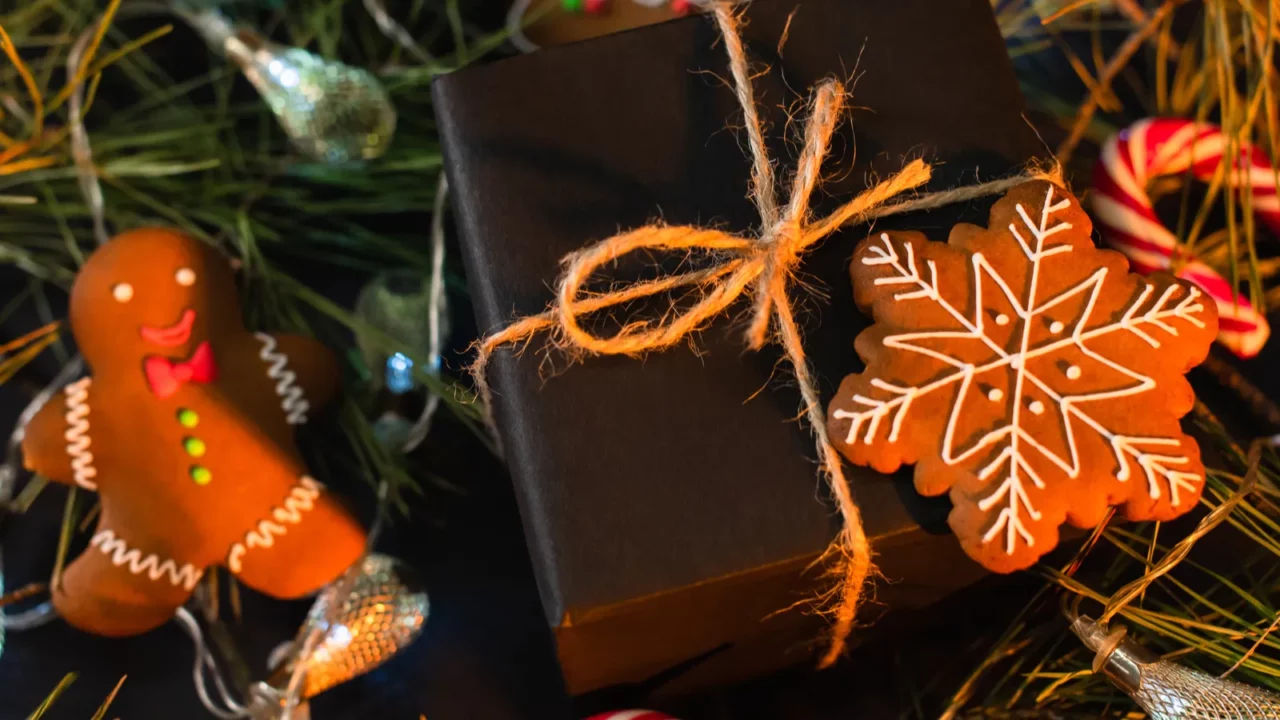 high angle view of wrapped black gift box with gingerbread