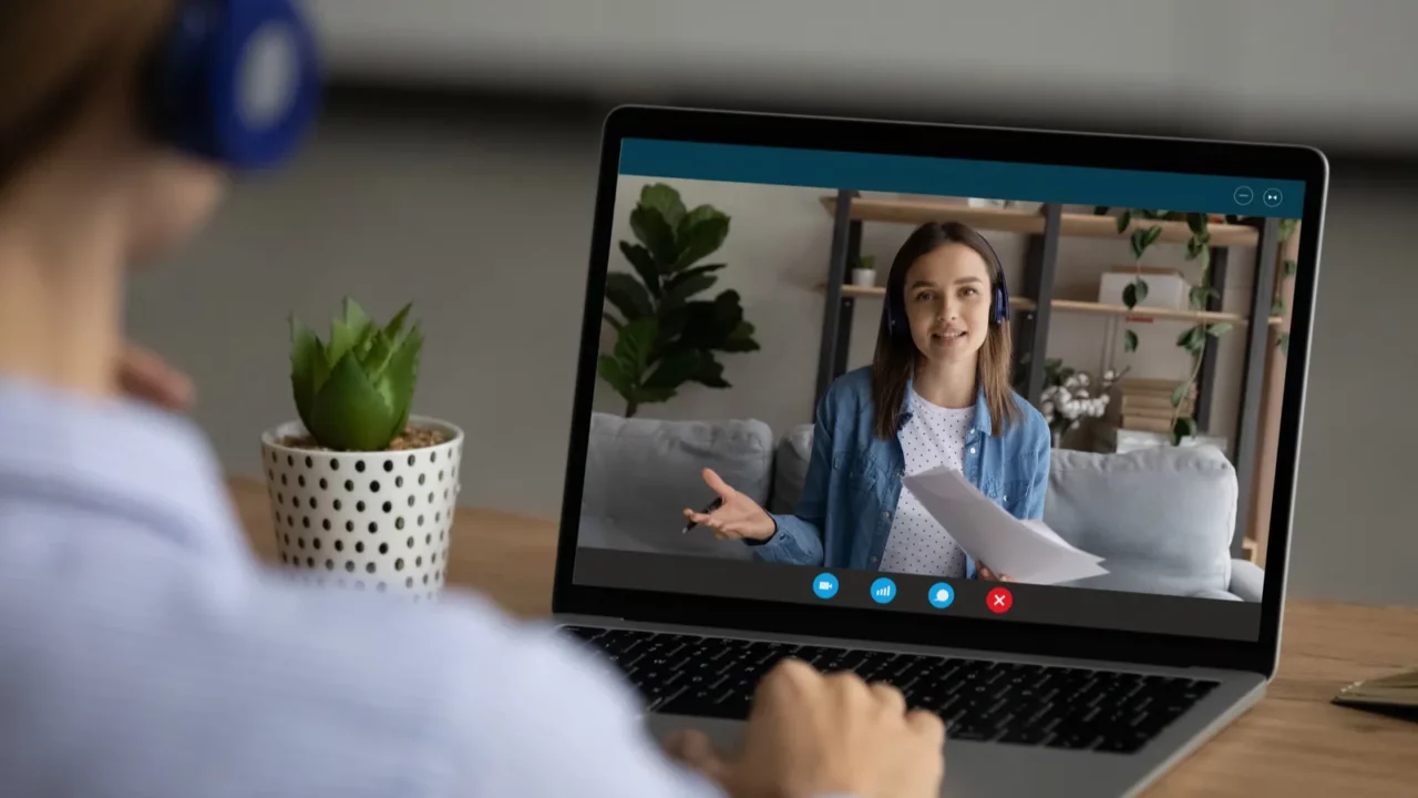 Woman talking on webcam call with female colleague.