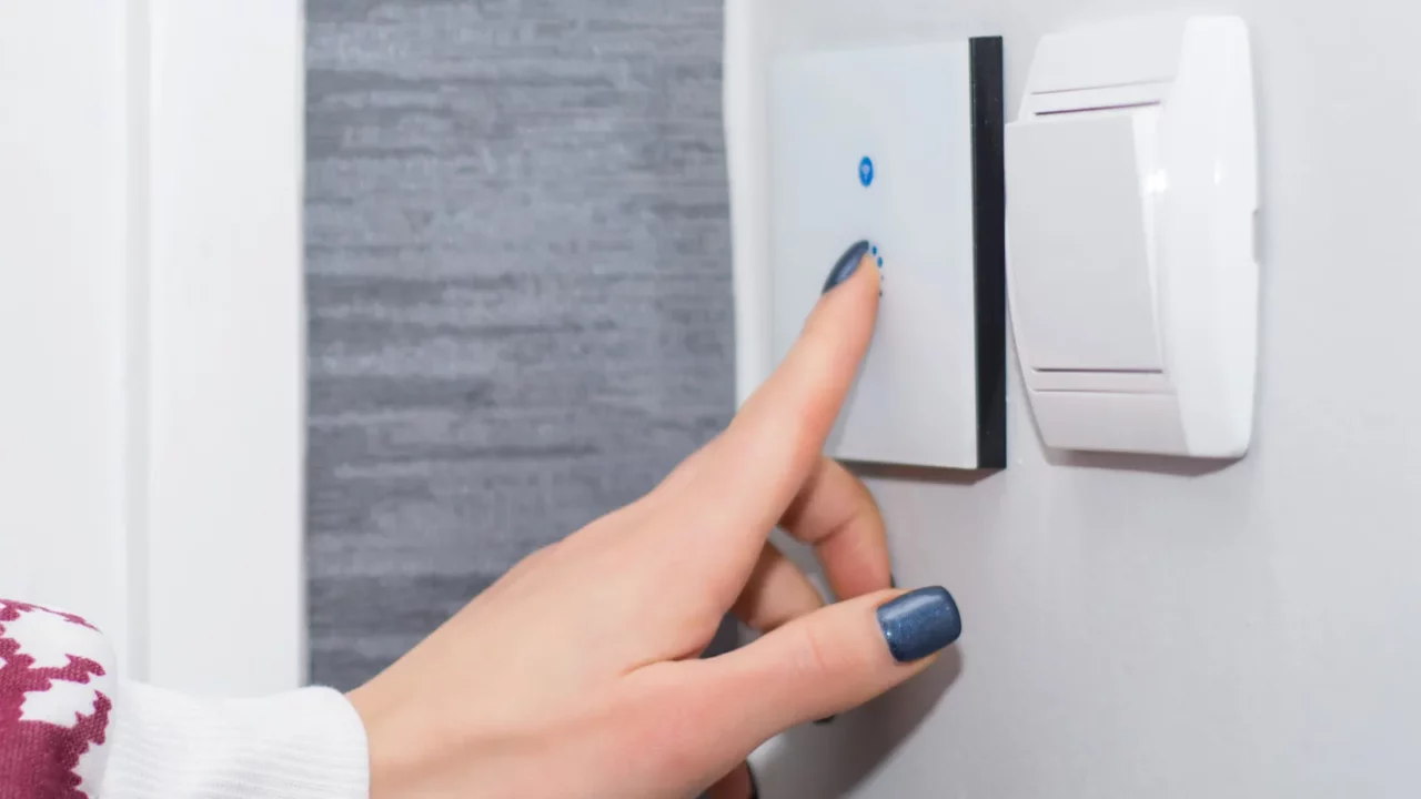 girl hand turn off light on smart touch switch modern