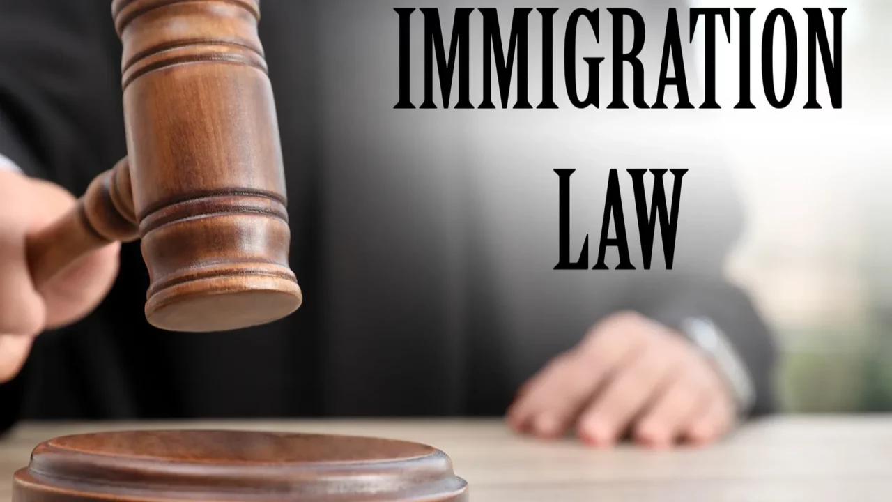 judge with gavel at table in courtroom closeup immigration law