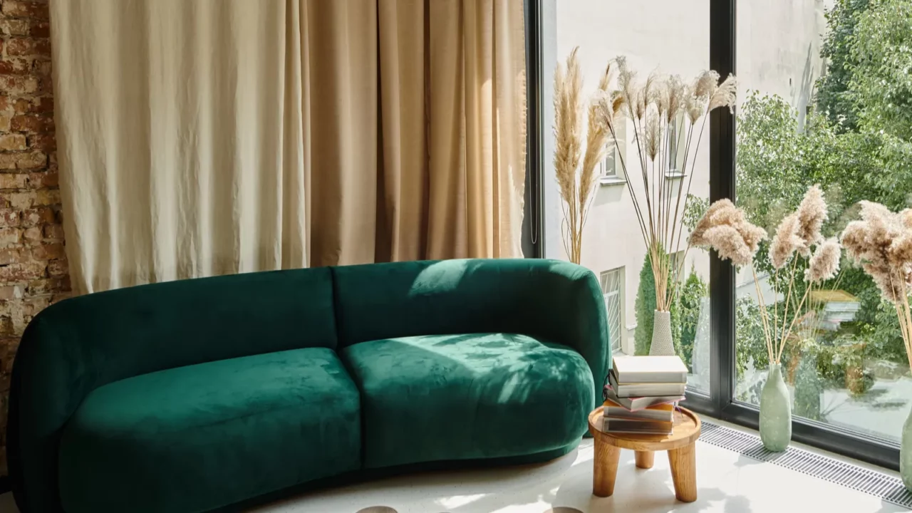 modern apartment with blue velour sofa books on coffee table